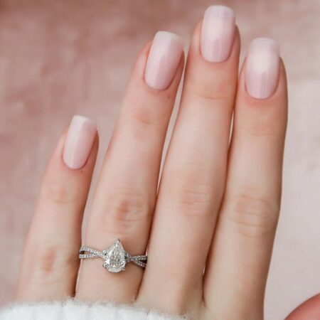 Pear Cut Hidden Accent Twisted Band Moissanite Ring